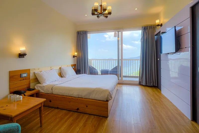 Cozy interior bedroom of Group Cottage Booking — Ramgarh's Best Rate for Large Families at Whispering Pines Resort Mukteshwar, Uttarakhand