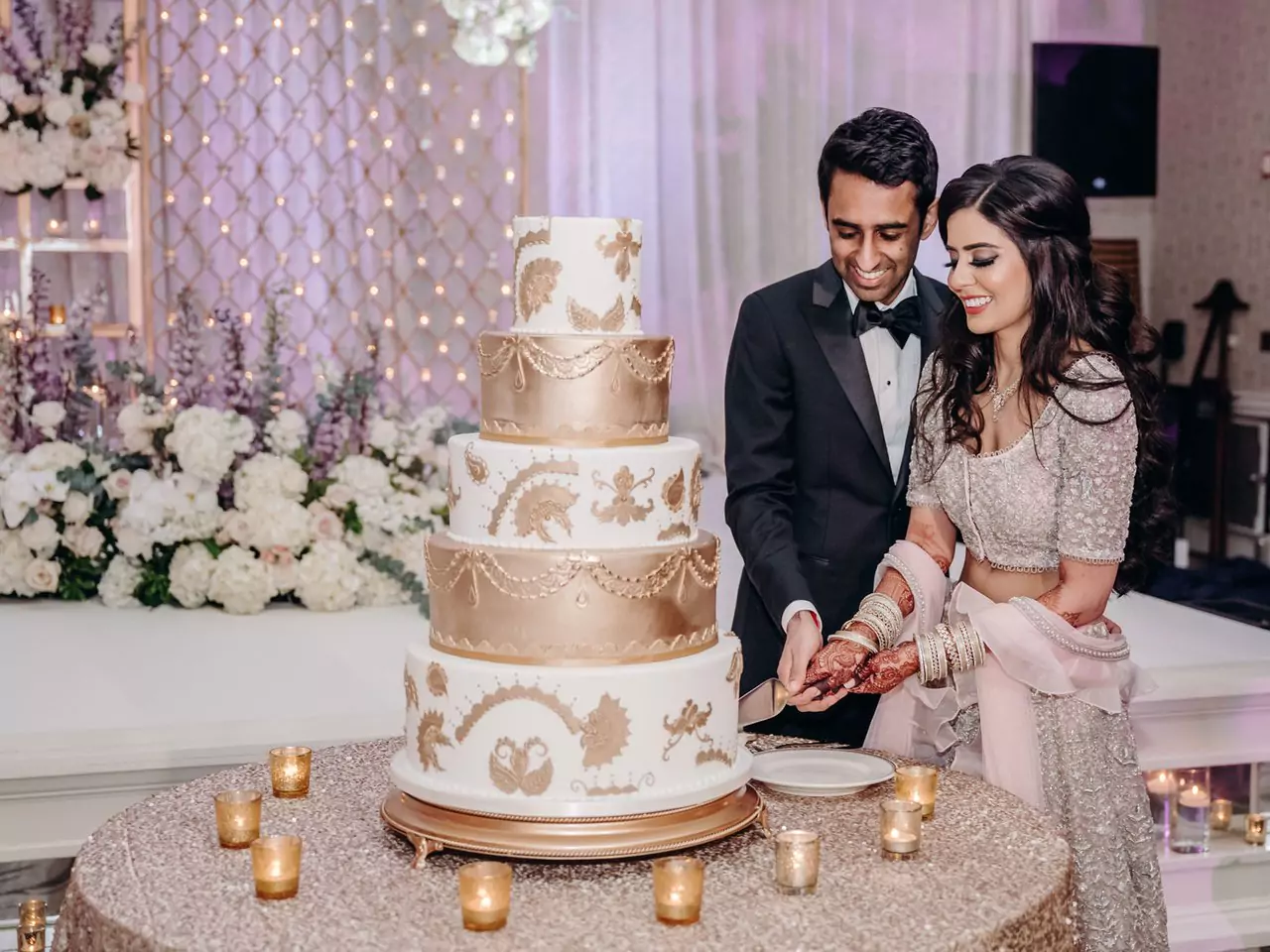 Artisanal multi-tiered wedding cake cutting ceremony at Whispering Pines Resort